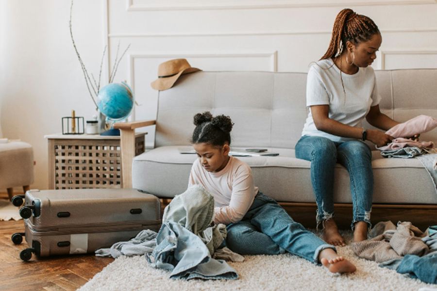 Girl and Mom packing luggage